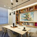 New York City conference room with layered lighting design including pendant lights over island and under-cabinet task lighting